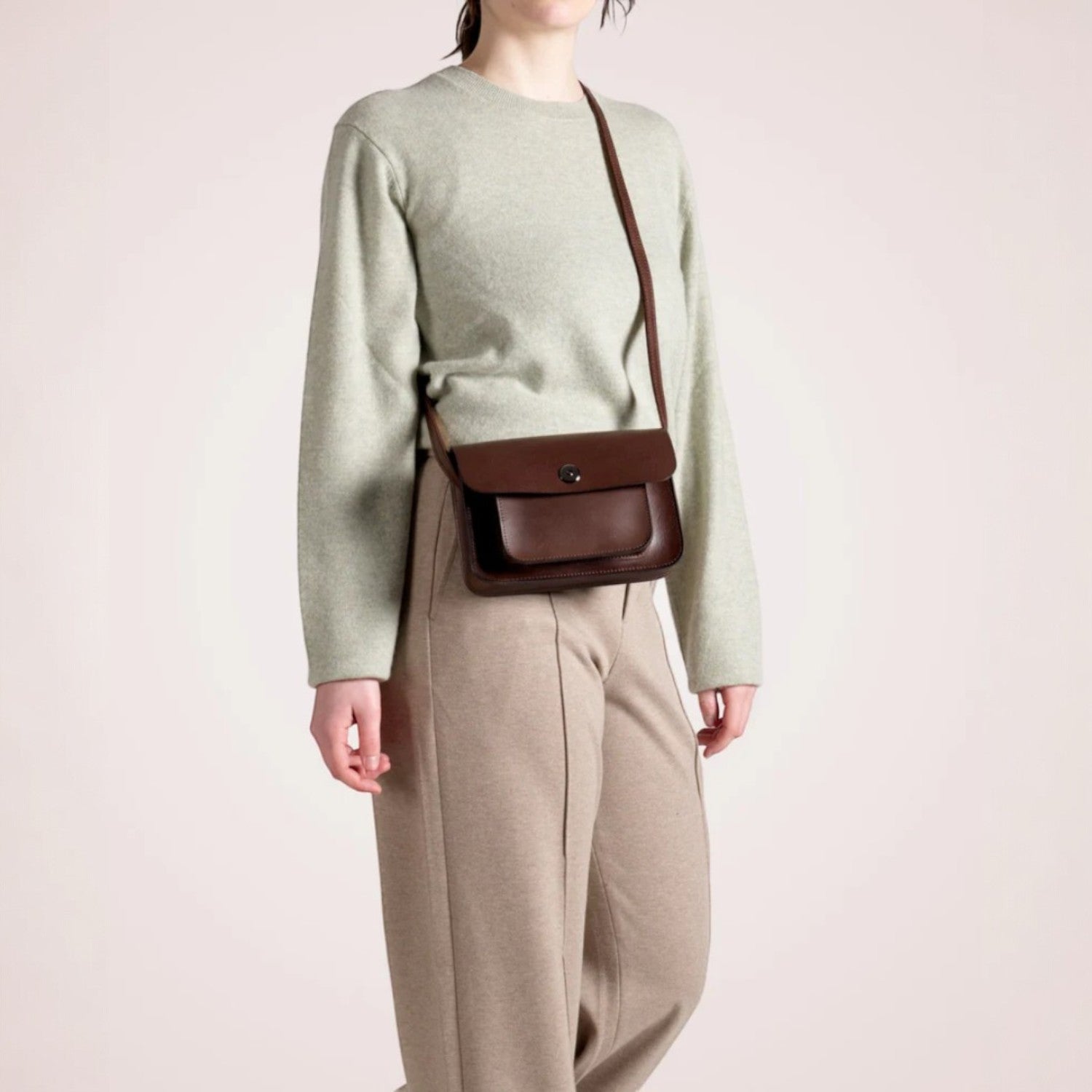 Lieblingstasche Abby dark brown leather crossbody bag with front pocket and silver clasp.