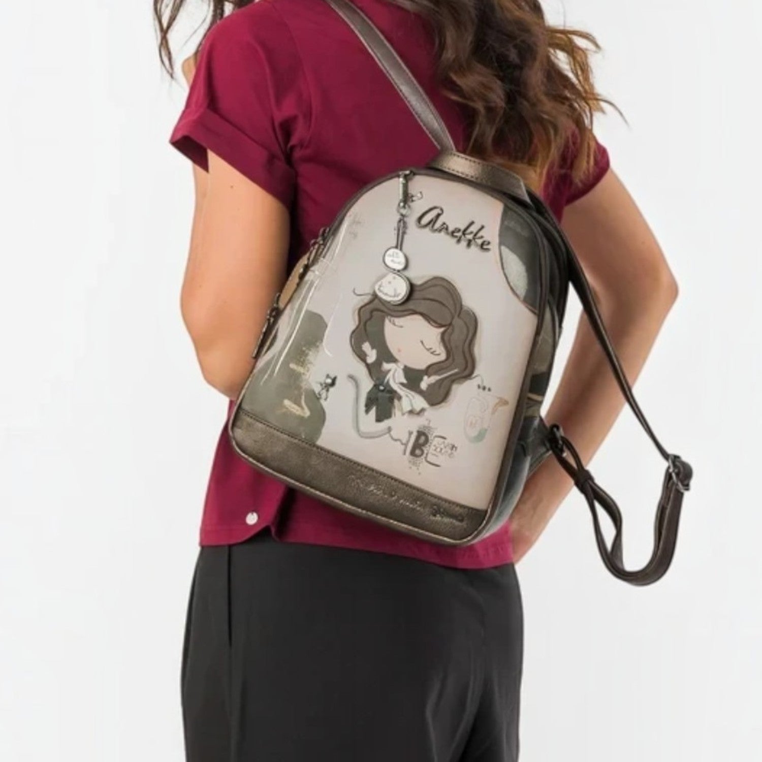 Woman wearing a Lieblingstasche Anekke backpack with illustrated character design and metallic bronze trim