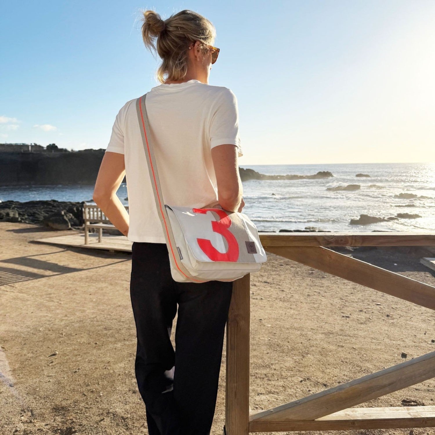 Lieblingstasche Barkasse Mini messenger bag in light grey with a large red number 3 graphic and orange trim.