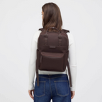 Lieblingstasche Bergen Pro dark brown backpack worn by a woman with a white long-sleeve top and blue jeans