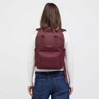Lieblingstasche Bergen Pro backpack in burgundy worn by a woman against a white background