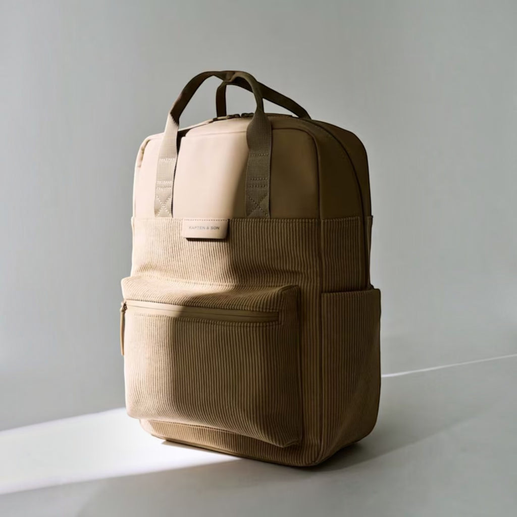Lieblingstasche Bergen Pro Cord backpack in beige featuring a textured corduroy front pocket and top carry handles.