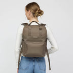 Lieblingstasche Bergen Pro backpack in taupe worn by a woman, featuring padded straps and a laptop compartment.