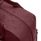 Lieblingstasche Bergen Pro backpack in dark red waterproof material with water droplets on the surface