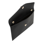 Lieblingstasche black pebbled leather clutch with gold hardware, open to show interior.