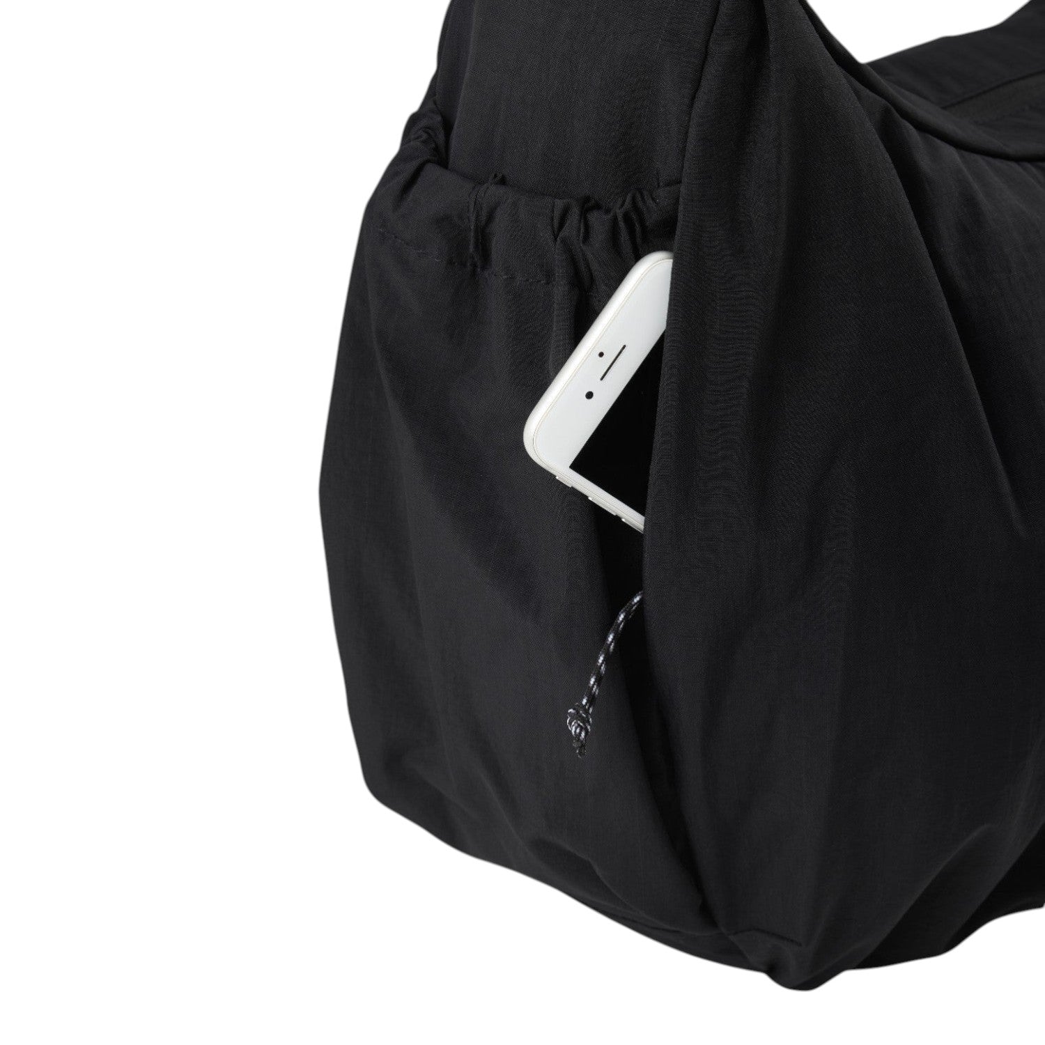 Lieblingstasche black slouchy bag featuring a convenient side pocket with a white smartphone tucked inside