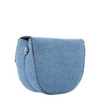 Lieblingstasche blue denim flap bag with curved silhouette and black trim.