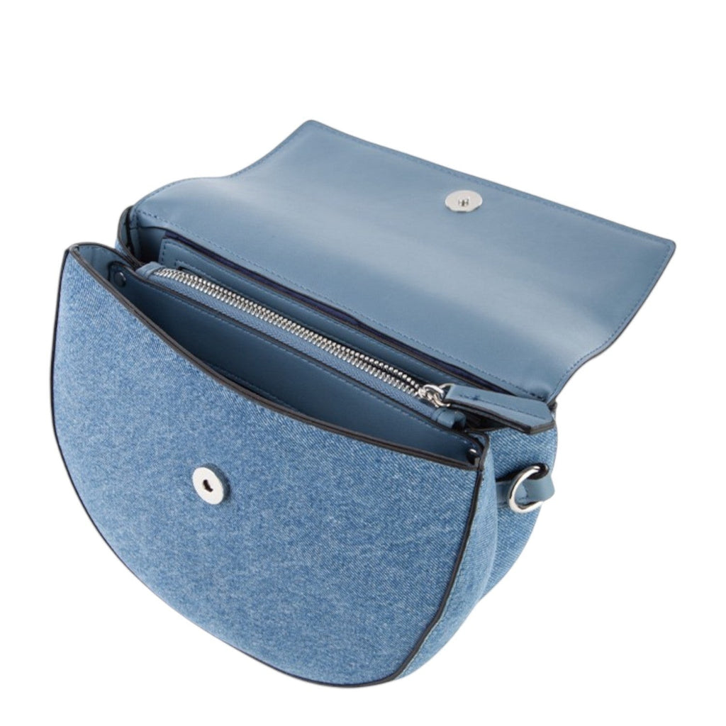 Lieblingstasche blue denim flap bag with silver hardware and a snap closure. The bag has a zipped compartment inside.