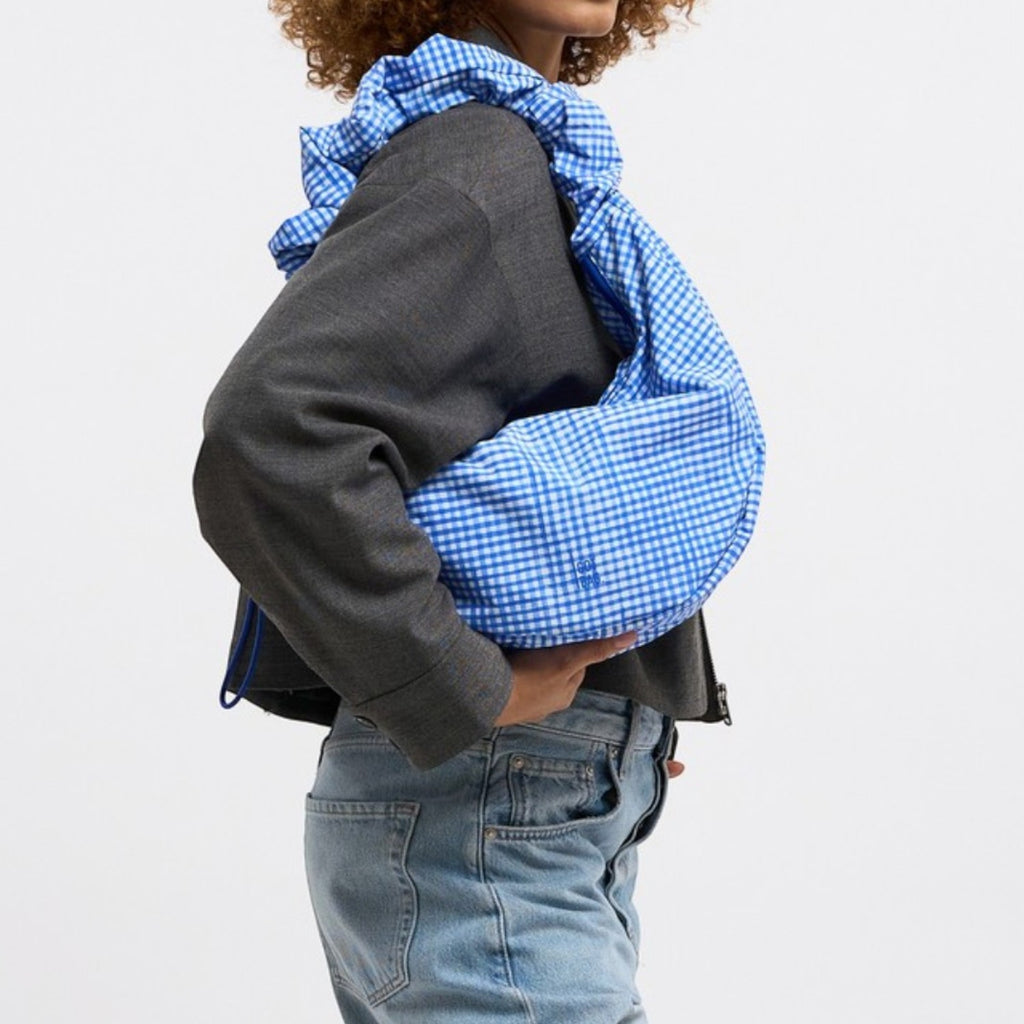 Lieblingstasche Moon Bag Ruffle Large in blue gingham fabric with ruffled trim.