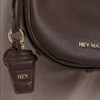 Lieblingstasche Coffee Charm dark brown pebbled leather crescent crossbody bag with gold hardware and logo charm