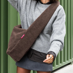 Lieblingstasche brown teddy fleece moonbag worn as a crossbody bag over a grey sweater