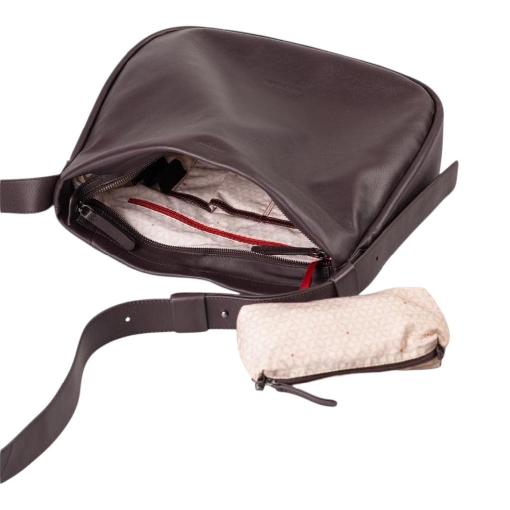 Lieblingstasche Coral dark brown leather shoulder bag with an open main compartment and a small patterned pouch.