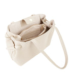Lieblingstasche cream faux leather tote bag with interior zip pocket and snap closure.