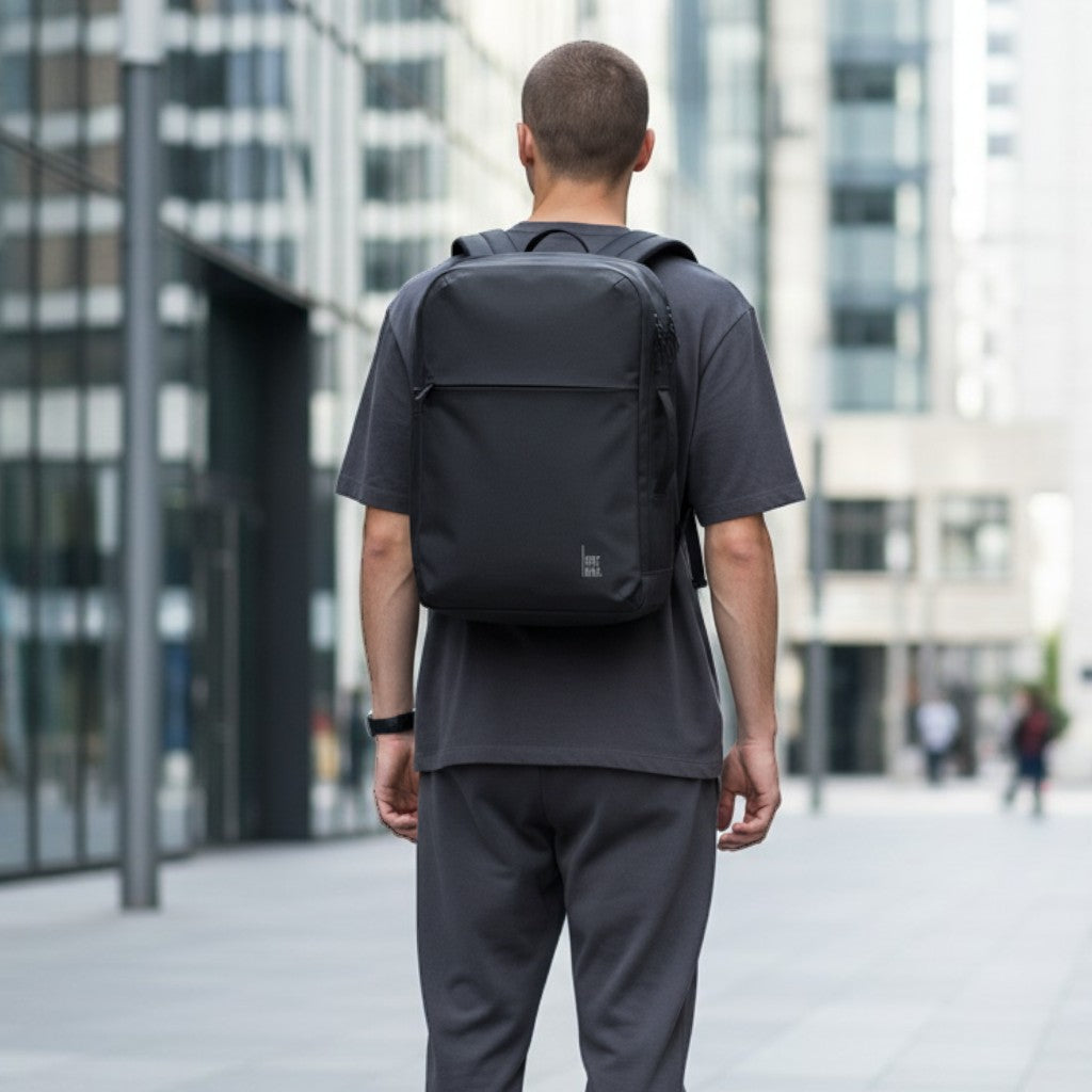 Lieblingstasche Commuter Pack, a minimalist dark grey backpack with a front zip pocket and dual zip main compartment.