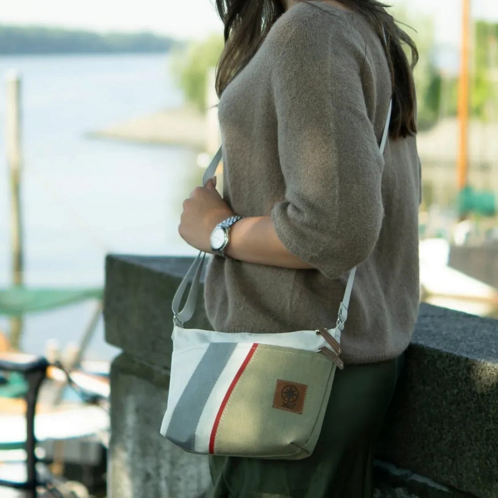 Lieblingstasche Deern Lütt crossbody bag in olive and white canvas with grey and red striped detail worn outdoors