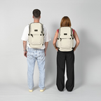 Lieblingstasche eoto Easy27 beige everyday backpack worn by a man and woman against a light grey background