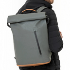 Lieblingstasche a/u by aunts & uncles Fukui rolltop backpack in grey coated canvas with tan leather details on a man