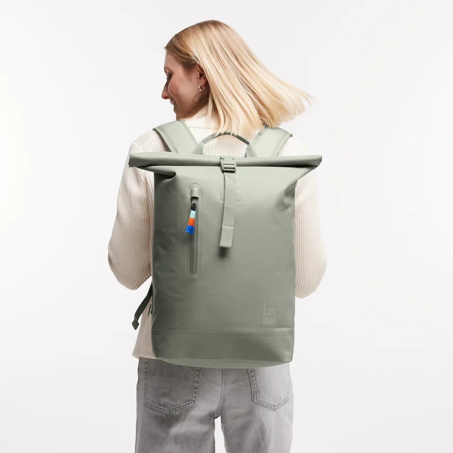 Lieblingstasche GOT BAG Rolltop Lite 2.0 sage green waterproof backpack worn by a woman with adjustable straps