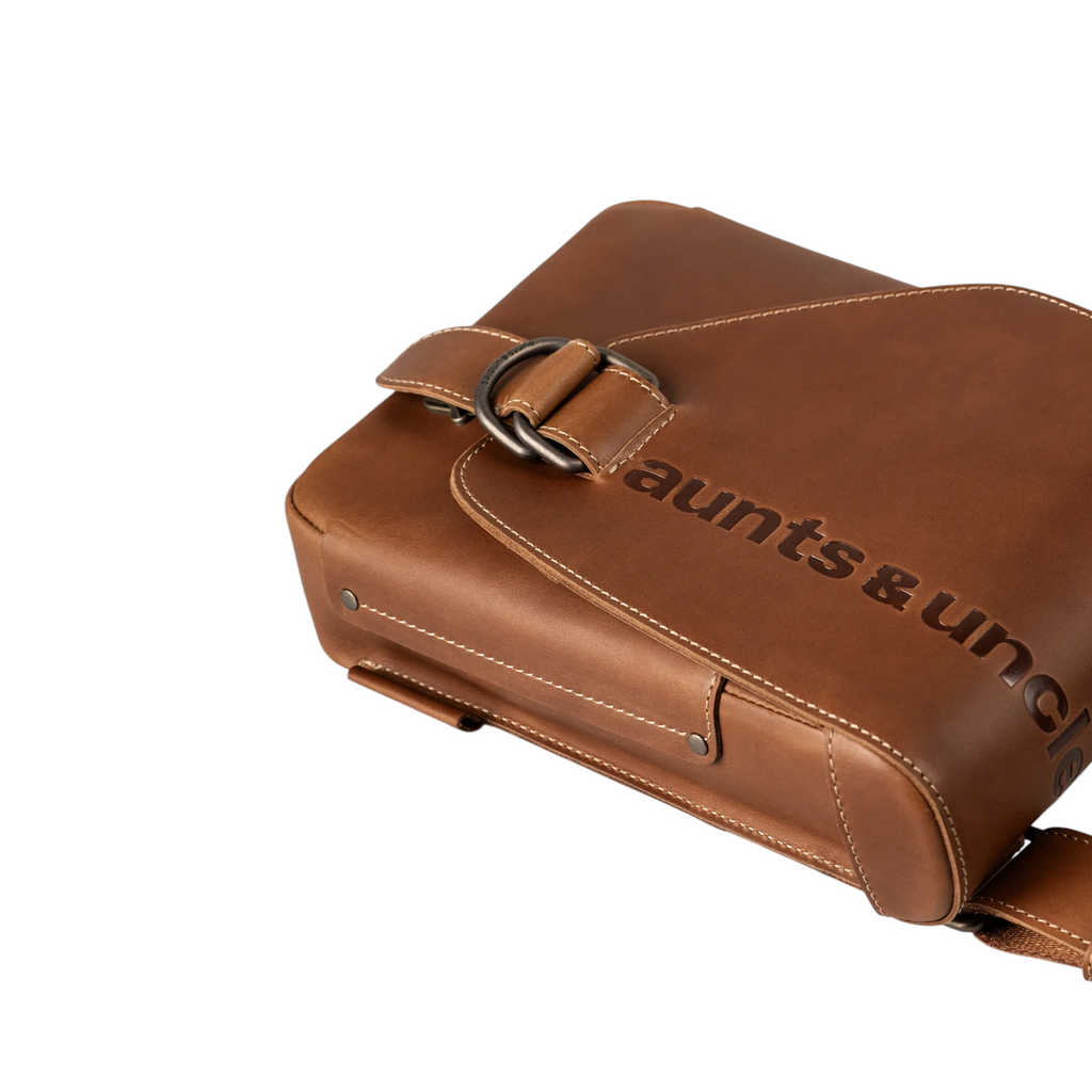 Lieblingstasche Jade brown leather crossbody bag with embossed aunts & uncles logo and antique metal buckle detail.