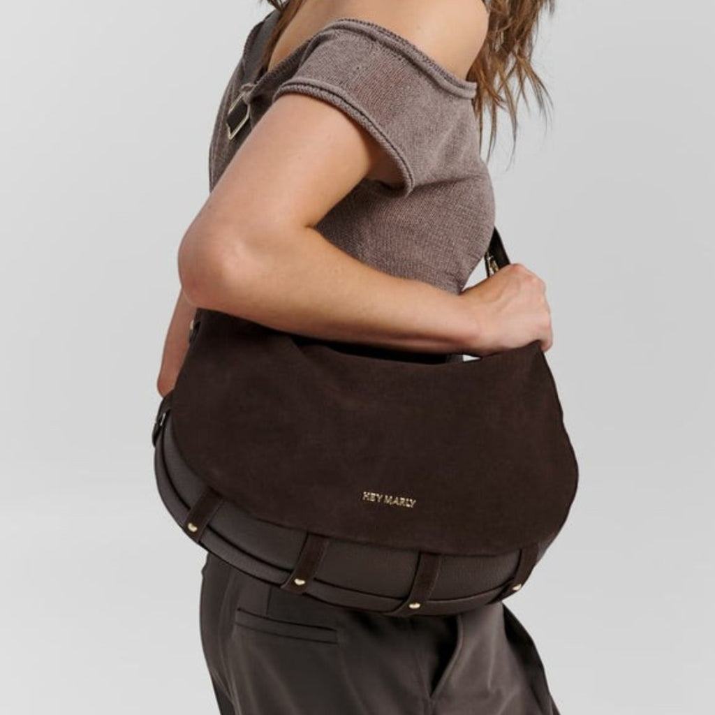 Lieblingstasche Lifetime Sister suede shoulder bag in dark brown with gold hardware worn by a woman