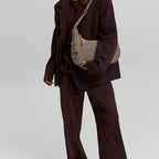 Lieblingstasche Lifetime Sister Suede M shoulder bag in taupe worn by a model in a dark suit