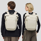 Lieblingstasche Lisbon Small beige roll-top backpack worn by a man and woman for travel and daily use