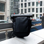 Lieblingstasche Lisbon small black rolltop backpack with laptop compartment and anti-theft pocket in urban setting