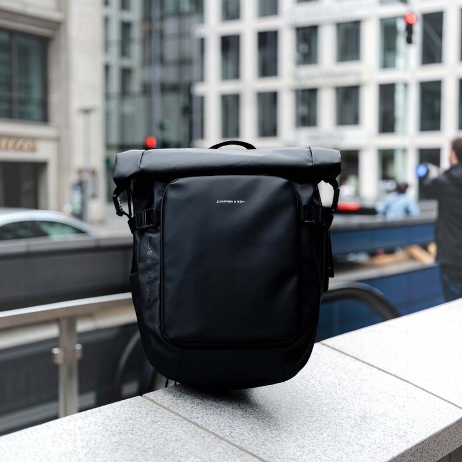 Lieblingstasche Lisbon small black rolltop backpack with laptop compartment and anti-theft pocket in urban setting
