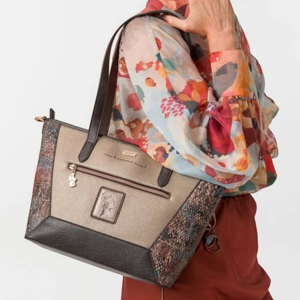Lieblingstasche shoulder bag in metallic gold and brown with textured side panels carried by a woman