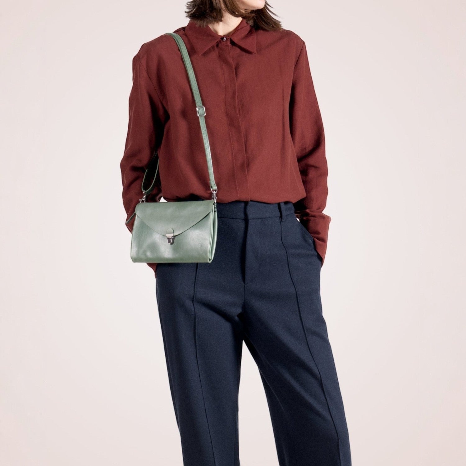 Lieblingstasche mint green leather fold handbag clutch with silver clasp and adjustable strap.