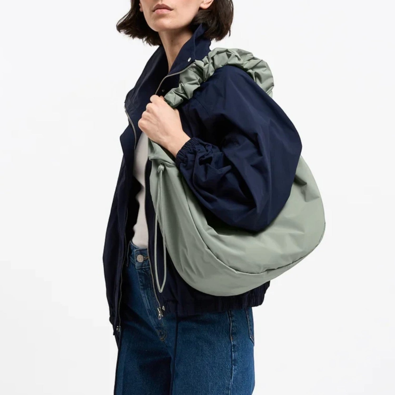 Lieblingstasche Moon Bag Ruffle Large in sage green made from recycled fishing nets worn over the shoulder
