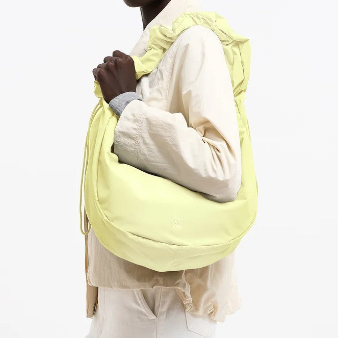 Lieblingstasche Moon Bag Ruffle Large in pale yellow with a gathered shoulder strap worn over the shoulder