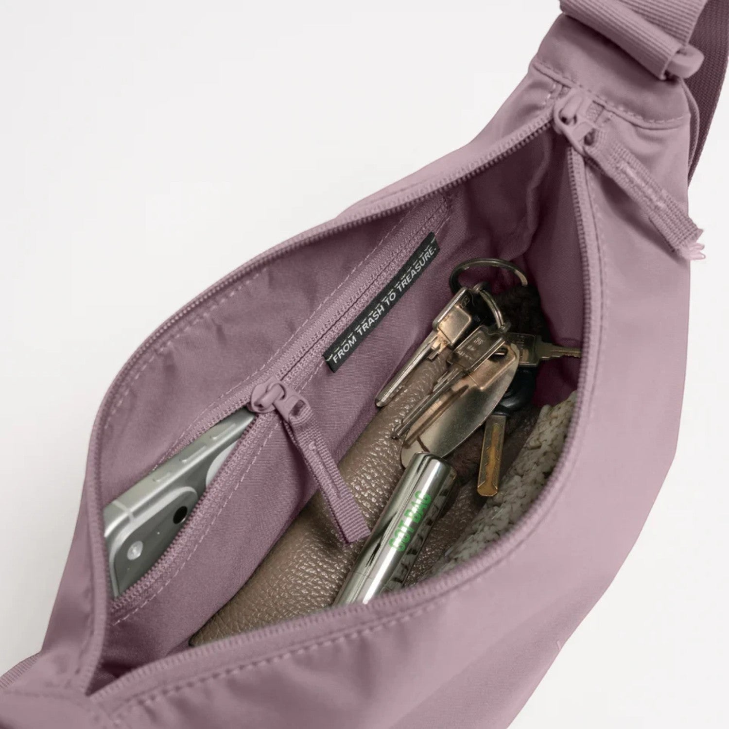 Lieblingstasche Moon Bag Small in dusty purple with open zipper showing internal pocket and personal items