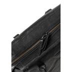 Close-up of the black leather Mrs. Profiterole handbag by Lieblingstasche featuring a sturdy metal zipper closure.