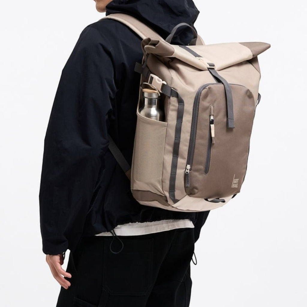 Lieblingstasche Rolltop Adventure backpack in beige and brown with grey accents, featuring a water bottle pocket.