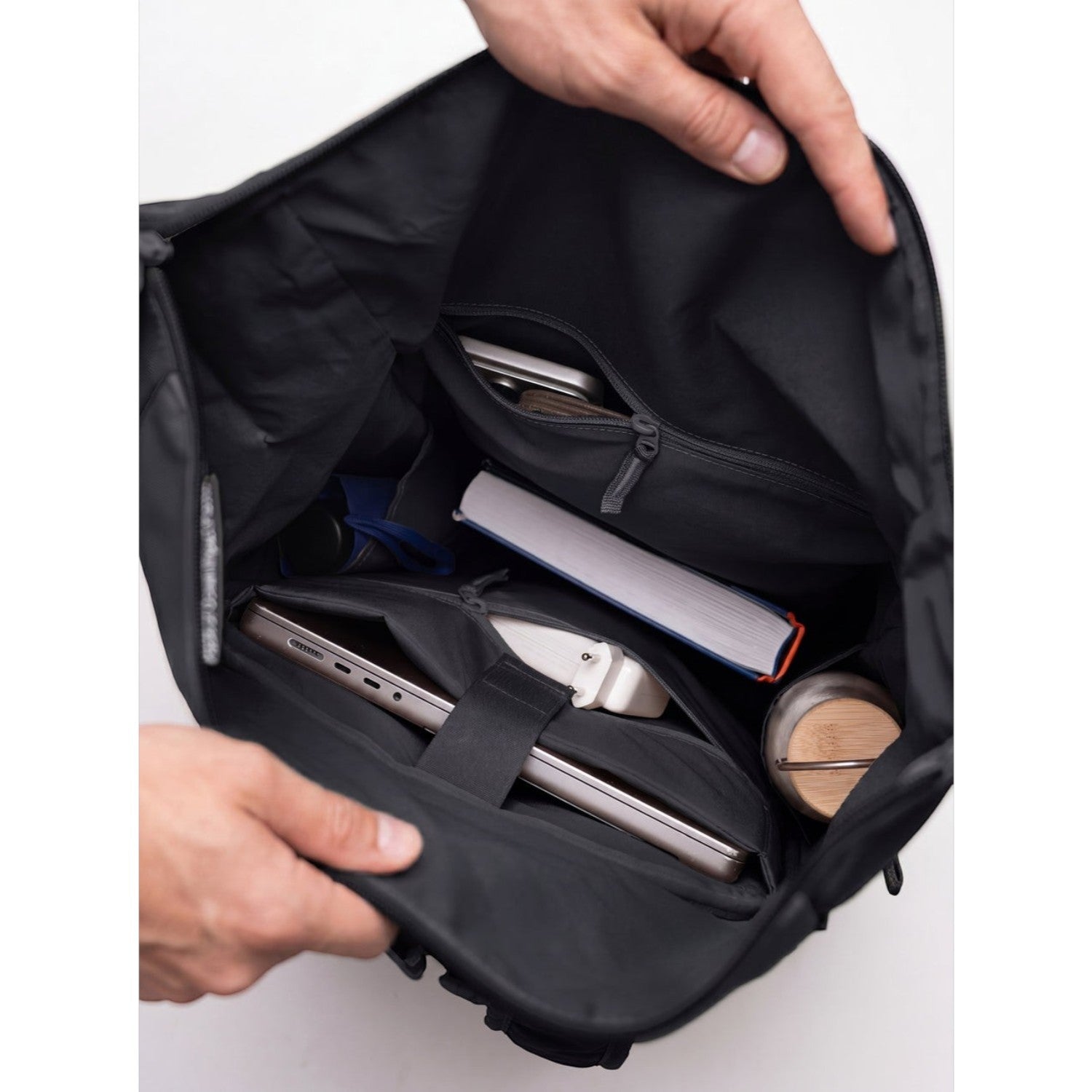 Lieblingstasche Rolltop Adventure backpack interior with laptop, book, phone, and water bottle