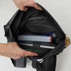 Lieblingstasche Rolltop Easy Small backpack interior view showing laptop compartment, book, and water bottle storage.