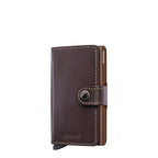 Lieblingstasche Secrid Miniwallet in dark brown leather with a snap button closure and integrated card protector.