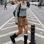 Lieblingstasche Skara Small black crossbody bag worn by a woman walking on a city street