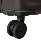 Close-up of a durable black spinner wheel on a Lieblingstasche 2WANDER suitcase against a dark brown shell.