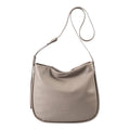 Lieblingstasche Coral taupe leather hobo shoulder bag with an adjustable strap against a white background
