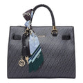 Lieblingstasche Tote M handbag in black with a monogram pattern, braided handles, and a decorative silk scarf charm.