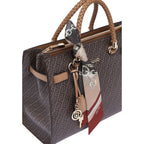 Lieblingstasche Tote M handbag in brown with a monogram pattern, braided handles, and a decorative silk scarf.
