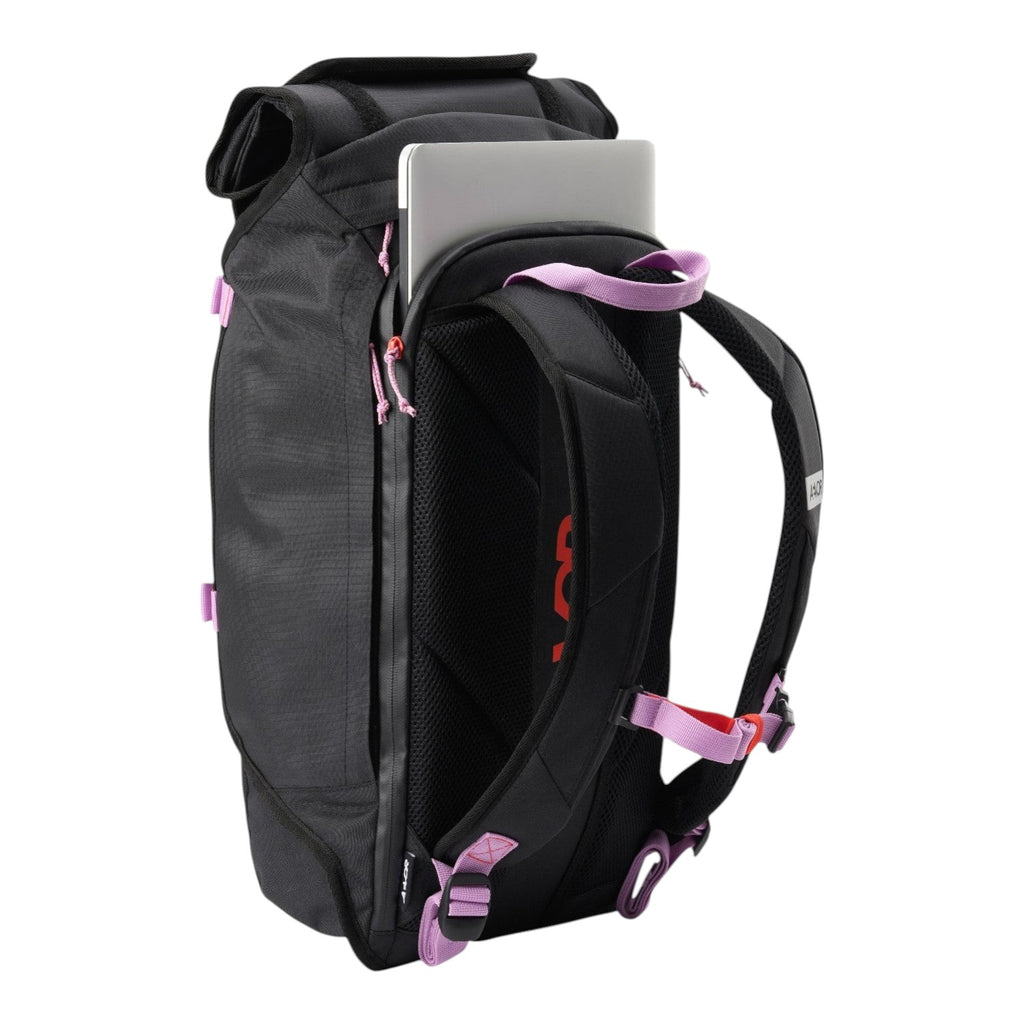 Lieblingstasche Trip Pack black roll-top backpack with laptop compartment, pink accents, and padded shoulder straps.