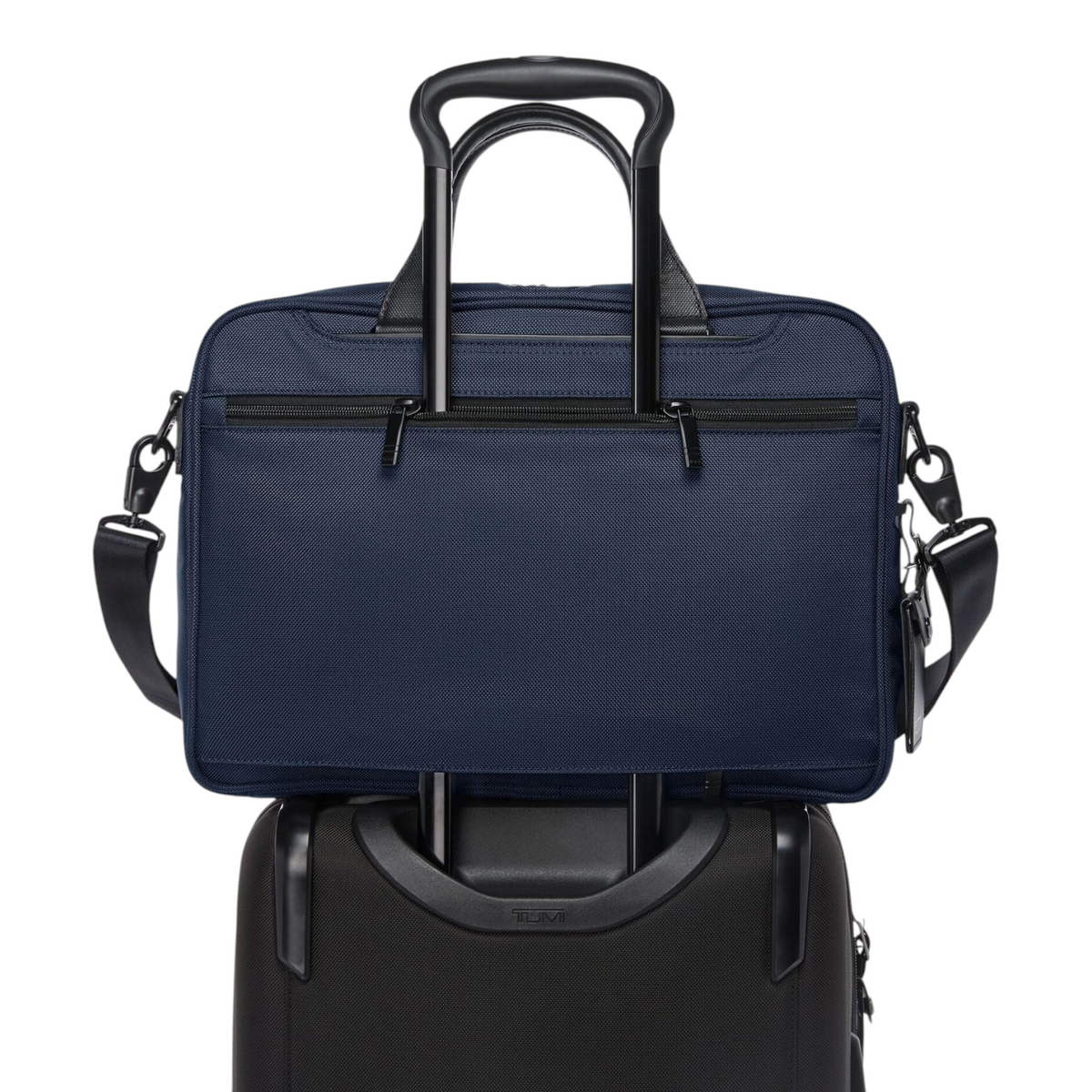 Lieblingstasche Tumi Alpha medium 15-inch navy blue briefcase attached to a black rolling suitcase handle