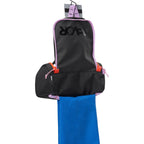 Lieblingstasche Wash Pack hanging open with black fabric, purple trim, orange accents, and a blue towel inside.